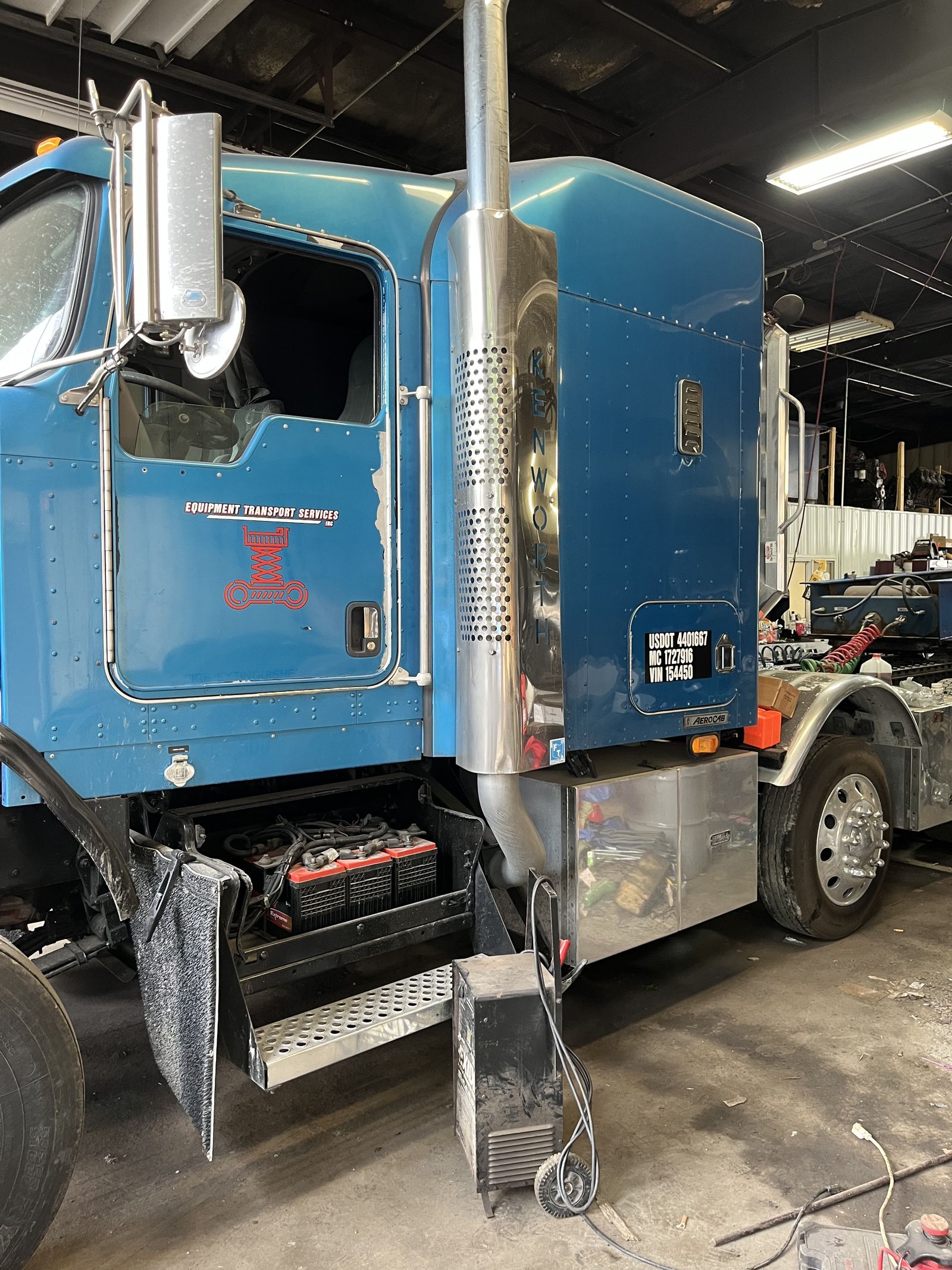 Equipment Repair Services truck in the shop with company logo on door