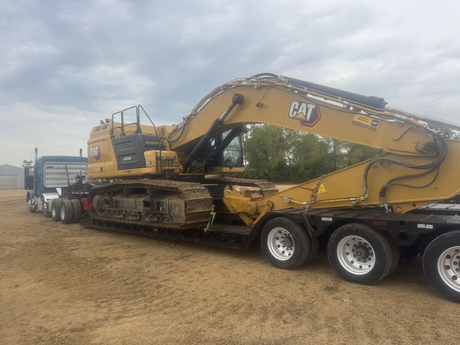 CAT excavator loaded on lowboy trailer
